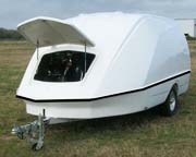 Enclosed motorcycle trailer - fuel efficient, lightweight and aerodynamic fiber reinforced plastic with an aluminum frame